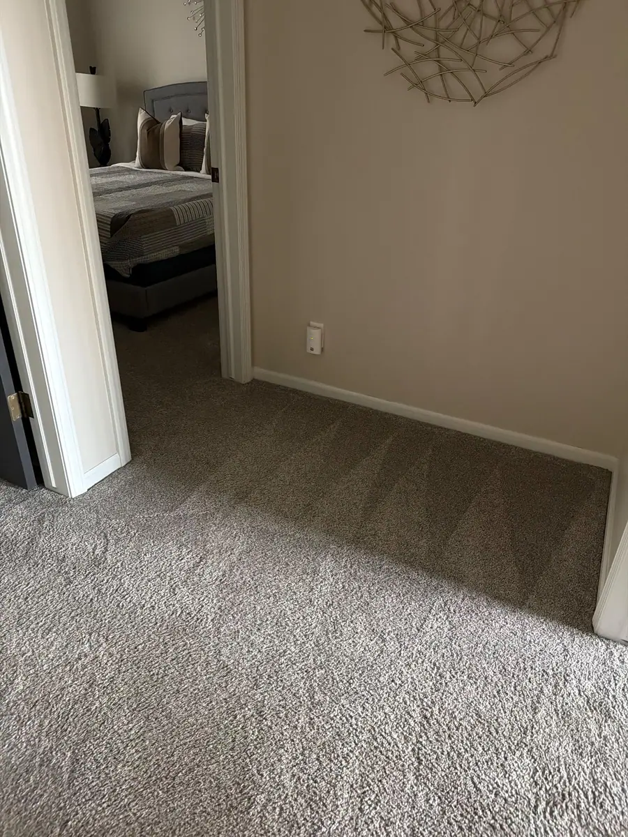 Freshly vacuumed carpet with clean lines in an upstairs hallway