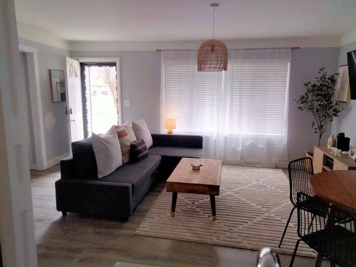 Living room with a dark sofa and wood coffee table after a clean