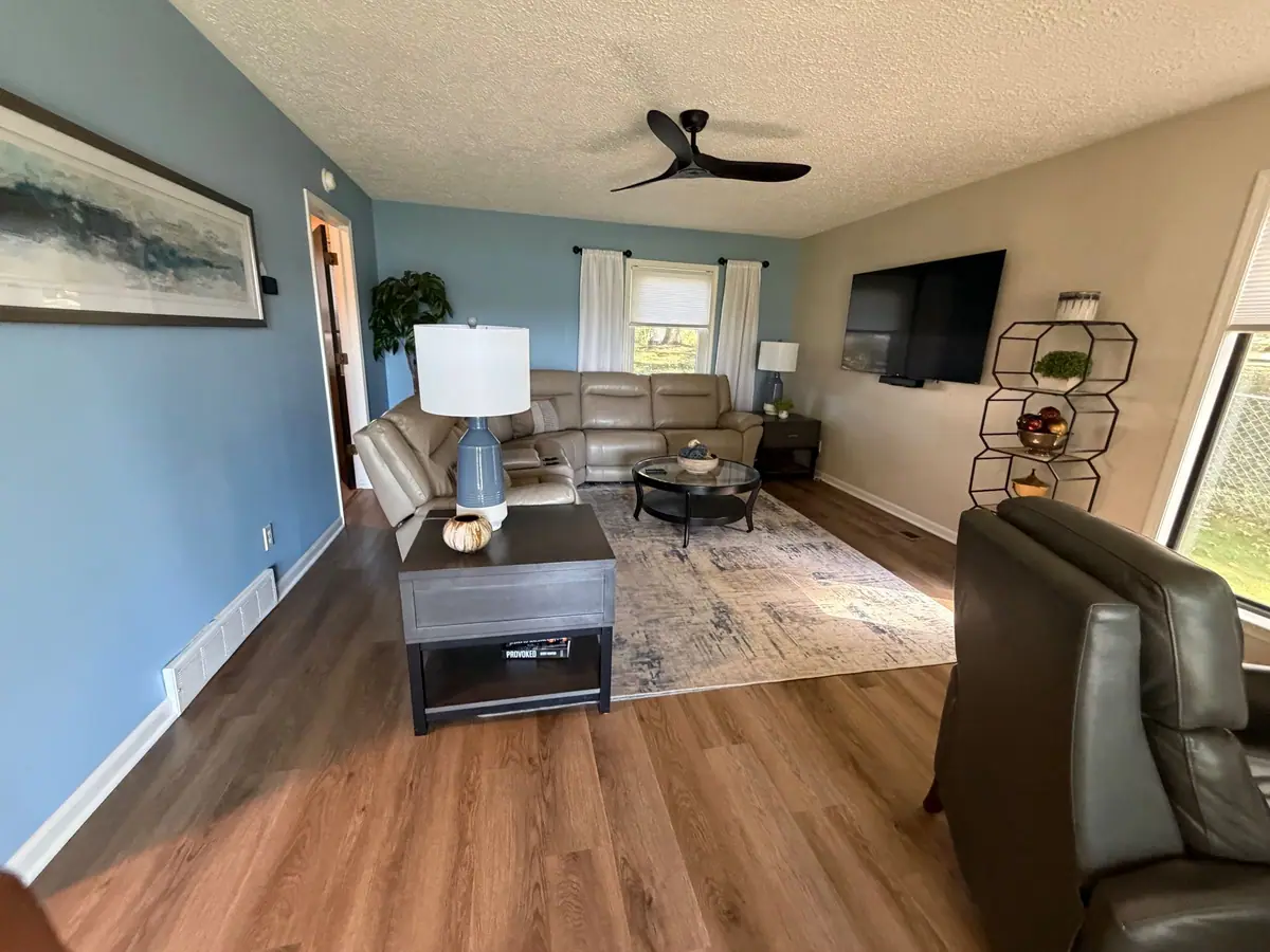 Living room with wood floors, cleaned and put back together