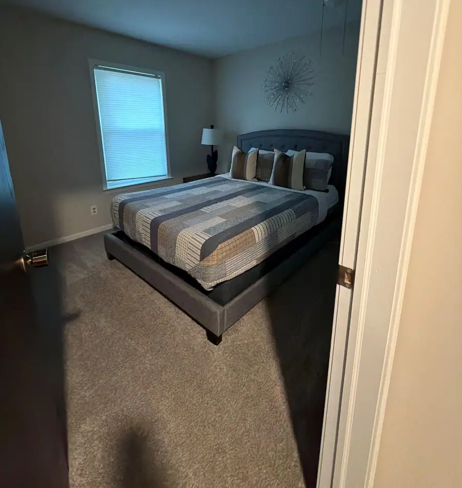 Queen bedroom made up, seen from the doorway
