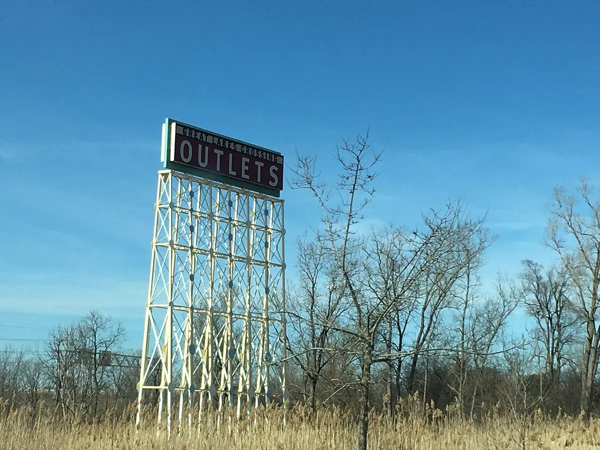 The Great Lakes Crossing Outlets sign against a blue sky in Auburn Hills