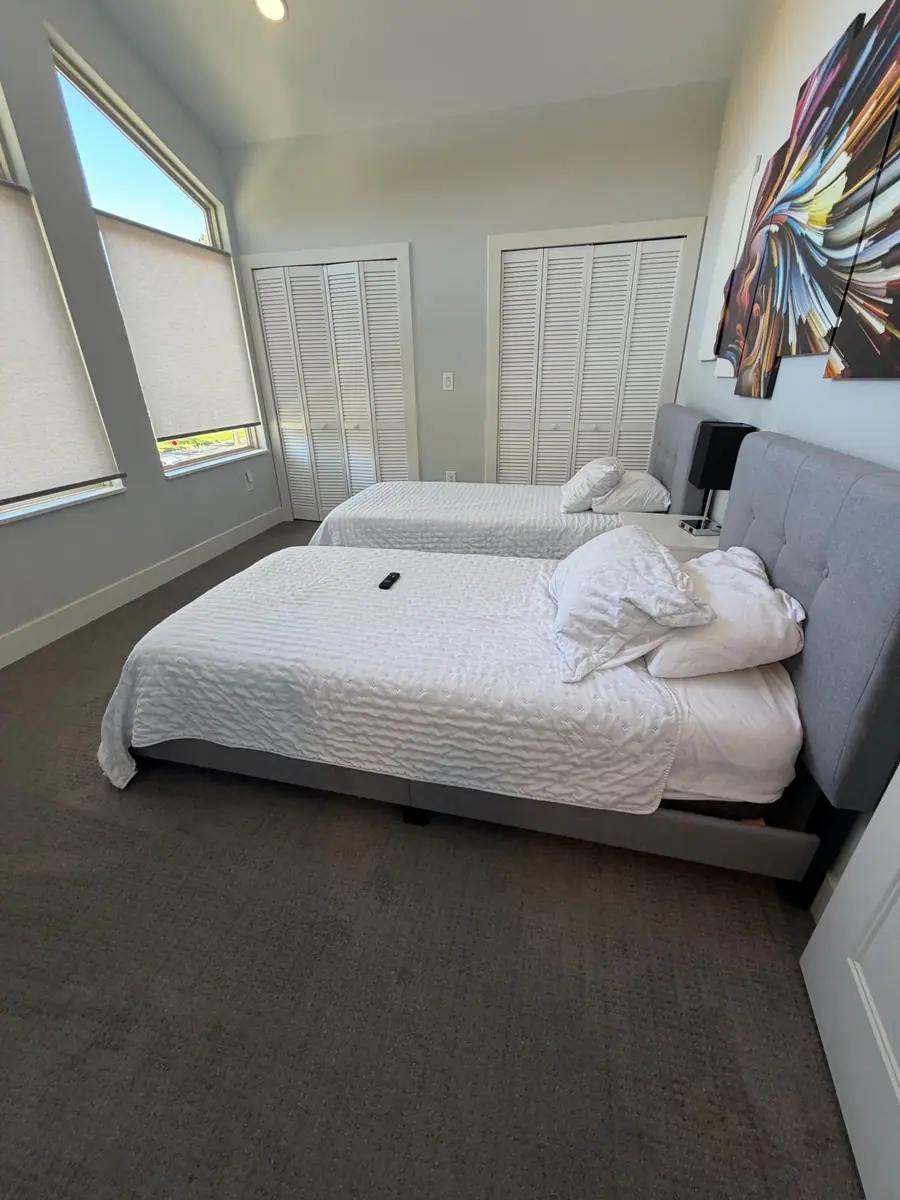 Twin room reset with white quilts for the next guests